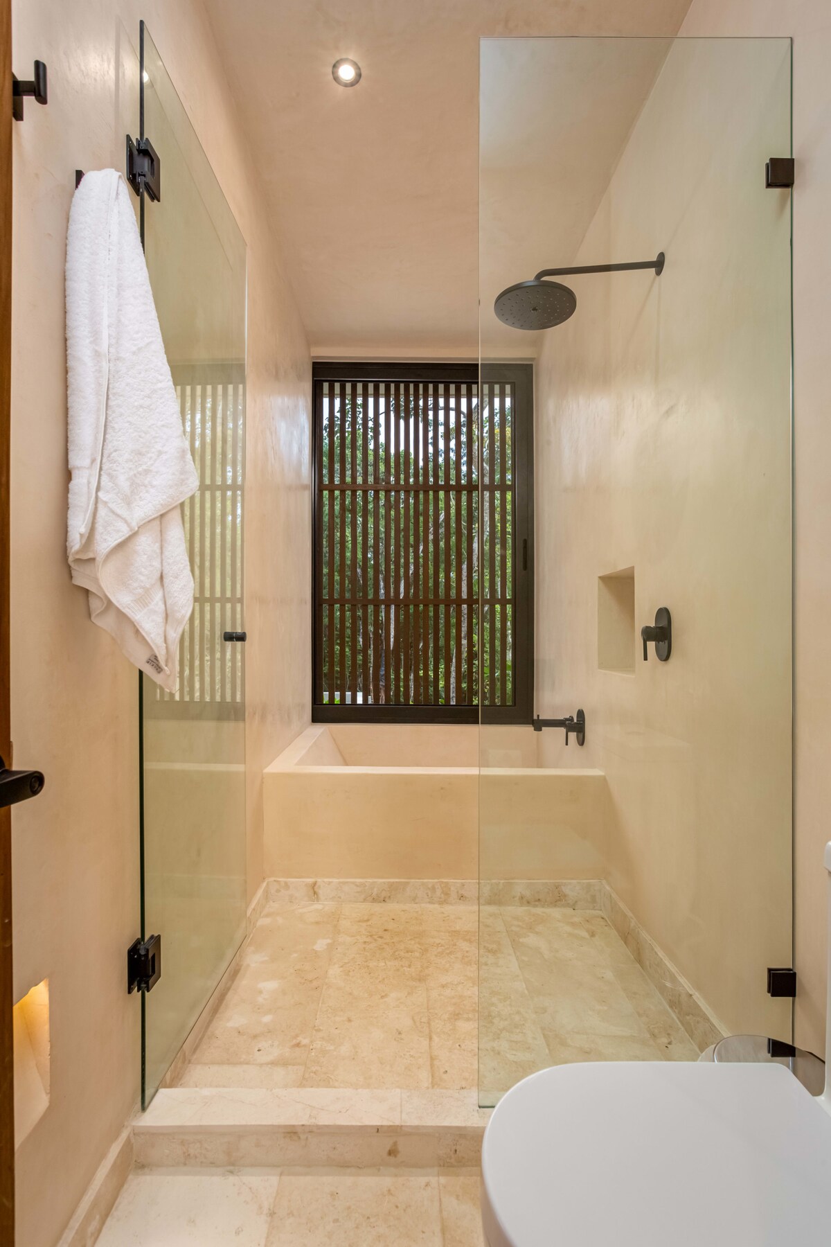 Community pool area surrounded by tropical greenery at AMARI Uptown Tulum