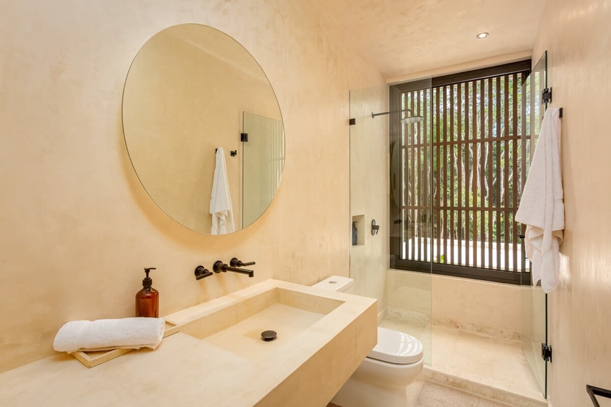 Private pool with evening lighting and tropical plants at Luxury Jungle VIBE Tulum
