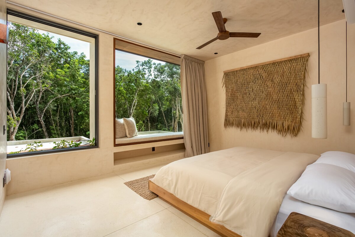 Night view of illuminated private pool and terrace at Luxury Jungle VIBE Tulum