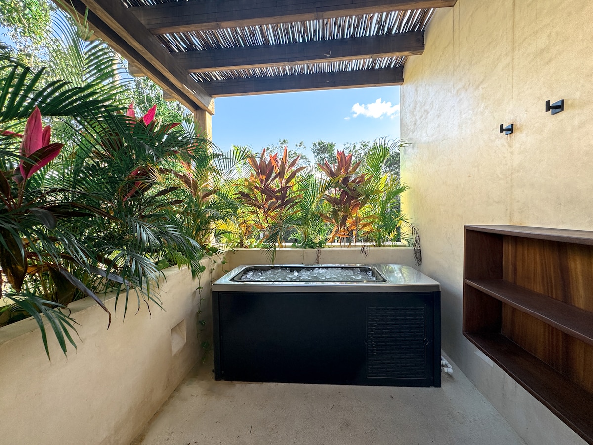 Kitchen breakfast bar with modern seating at Luxury Jungle VIBE Tulum villa